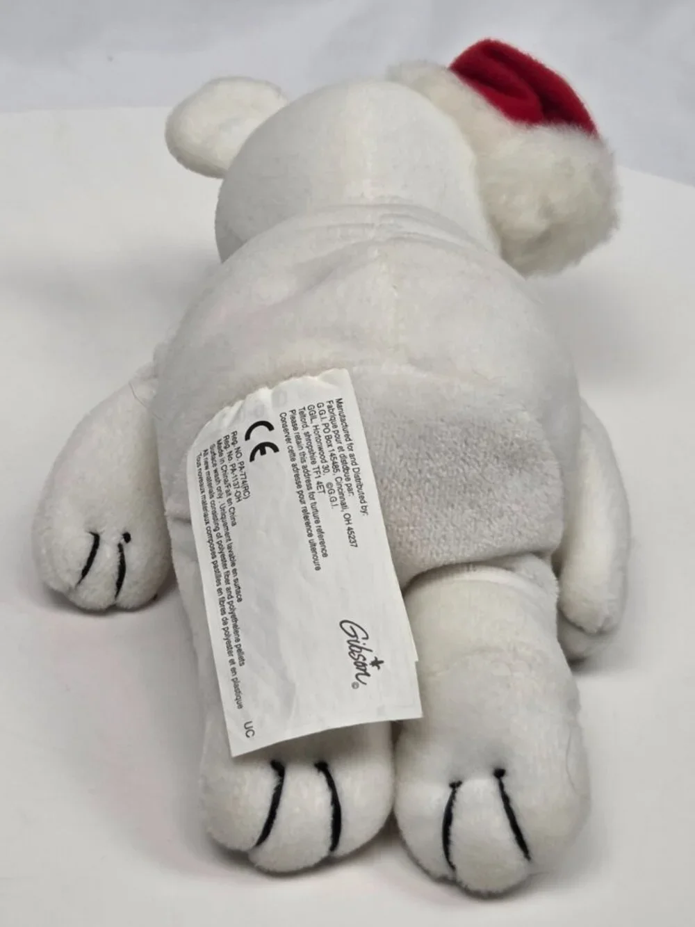 white plush holiday teddy bear wearing a small red Santa hat 8